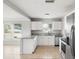 Bright, updated kitchen features stainless steel appliances, granite counters, and modern white cabinetry at 2728 39Th N Ave, St Petersburg, FL 33714