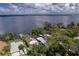 Breathtaking aerial view of the home nestled among lush trees, showcasing a waterfront property with a private dock at 297 Lakeview Dr, Tarpon Springs, FL 34689