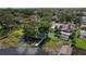 Aerial view showcasing a waterfront home with a private dock, pool, and meticulously manicured backyard at 297 Lakeview Dr, Tarpon Springs, FL 34689