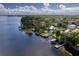 Breathtaking aerial view of lakefront homes with private docks and lush greenery on a sunny day at 297 Lakeview Dr, Tarpon Springs, FL 34689