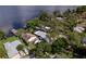 Areal view showcasing a waterfront property with a dock, lush greenery and mature trees at 297 Lakeview Dr, Tarpon Springs, FL 34689