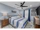 Inviting bedroom with blue walls, soft bedding, and a ceiling fan for a relaxing retreat at 297 Lakeview Dr, Tarpon Springs, FL 34689