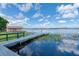 Scenic view of a private dock extending into a calm lake, perfect for boating and enjoying waterfront living at 297 Lakeview Dr, Tarpon Springs, FL 34689