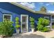 Inviting entryway featuring a storm door, manicured greenery, and tasteful decor elements enhancing curb appeal at 297 Lakeview Dr, Tarpon Springs, FL 34689