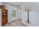 Welcoming foyer with stylish decor, wood-look flooring, and a charming corner cabinet at 297 Lakeview Dr, Tarpon Springs, FL 34689