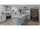 Open kitchen featuring a large center island with bar seating, stainless appliances, and a modern design at 297 Lakeview Dr, Tarpon Springs, FL 34689