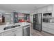 Modern kitchen with stainless steel appliances, white countertops, and hardwood floors at 297 Lakeview Dr, Tarpon Springs, FL 34689