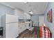 Well-lit laundry room boasts ample white cabinets, butcher block countertop, and modern washer and dryer units at 297 Lakeview Dr, Tarpon Springs, FL 34689