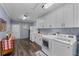 Spacious laundry room features a washer, dryer, plenty of cabinet space, butcher block countertop, and painted cinder block walls at 297 Lakeview Dr, Tarpon Springs, FL 34689