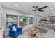 Bright living room with waterfront view, large windows, gray hardwood floors, and stylish decor at 297 Lakeview Dr, Tarpon Springs, FL 34689