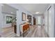 Spacious living room featuring stylish wood-look floors, neutral walls, and an abundance of natural light at 297 Lakeview Dr, Tarpon Springs, FL 34689