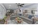 Spacious living room with an open concept, hardwood floors, gray sectional, and view into the kitchen at 297 Lakeview Dr, Tarpon Springs, FL 34689