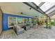 Inviting covered patio featuring stylish furniture, ceiling fans, and serene views at 297 Lakeview Dr, Tarpon Springs, FL 34689