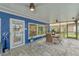 Covered patio featuring a dining set, tile flooring and ceiling fans at 297 Lakeview Dr, Tarpon Springs, FL 34689