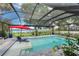 Relaxing screened in pool with comfortable seating and a lake view creates a perfect space for outdoor gatherings at 297 Lakeview Dr, Tarpon Springs, FL 34689