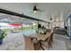 Covered patio overlooking the outdoor pool, with a dining set and comfortable seating at 297 Lakeview Dr, Tarpon Springs, FL 34689