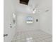 Bright bedroom with white tile floor, ceiling fan, and plenty of natural light at 3007 Aileen W St, Tampa, FL 33607