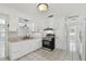 Kitchen with stainless steel appliances, white cabinetry and tile flooring at 3007 Aileen W St, Tampa, FL 33607