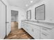 Bathroom with a double sink vanity with storage, and views into the bedroom at 3079 Osprey Ln, Clearwater, FL 33762