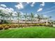 A beautifully landscaped clubhouse with palm trees offers a luxurious and inviting atmosphere for members and guests at 3079 Osprey Ln, Clearwater, FL 33762