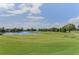 A pristine golf course with lush green fairways and a tranquil lake, offering a scenic and challenging experience at 3079 Osprey Ln, Clearwater, FL 33762