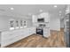 Open concept kitchen with white cabinets, stainless steel appliances, and a spacious layout at 3079 Osprey Ln, Clearwater, FL 33762