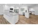 Modern kitchen with white cabinets, stainless steel appliances, and wood-look tile flooring at 3079 Osprey Ln, Clearwater, FL 33762