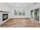 Well lit room with fireplace and backyard views, featuring new large format tile floors and neutral paint at 3079 Osprey Ln, Clearwater, FL 33762