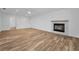 Spacious living room featuring beautiful wood-look tile floors and a cozy fireplace at 3079 Osprey Ln, Clearwater, FL 33762