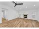 Spacious living room featuring recessed lighting, a modern ceiling fan, and a cozy fireplace at 3079 Osprey Ln, Clearwater, FL 33762
