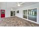 Covered patio with brick pavers, ceiling fans and sliding glass doors to the pool at 3079 Osprey Ln, Clearwater, FL 33762