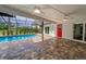 Screened in pool with brick paver deck, ceiling fans and an access door at 3079 Osprey Ln, Clearwater, FL 33762
