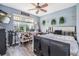 Bright bedroom with stylish decor and an abundance of natural light from the window overlooking backyard trees at 30817 Pumpkin Ridge Dr, Wesley Chapel, FL 33543