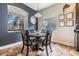 Intimate dining area with a round table, stylish chairs, decorative lighting, and ample natural light from nearby windows at 30817 Pumpkin Ridge Dr, Wesley Chapel, FL 33543