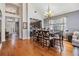 Inviting dining area that features hardwood floors, a modern chandelier, and seamless integration with the kitchen at 30817 Pumpkin Ridge Dr, Wesley Chapel, FL 33543