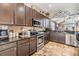 Well-equipped kitchen that features dark wood cabinetry, granite countertops, and stainless steel appliances at 30817 Pumpkin Ridge Dr, Wesley Chapel, FL 33543
