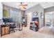 Office featuring a desk and computer with overhead lighting, neutral paint and decor, with a door to the bedroom at 30817 Pumpkin Ridge Dr, Wesley Chapel, FL 33543