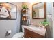 Charming powder room featuring a vanity with granite countertop, decorative mirror, and modern fixtures at 30817 Pumpkin Ridge Dr, Wesley Chapel, FL 33543