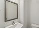 Neat bathroom featuring a modern sink, square mirror, and a toilet in a neutral color scheme at 3101 4Th N Ter, St Petersburg, FL 33713