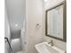 Simple and modern bathroom featuring a sink, square mirror, and a stairway view at 3101 4Th N Ter, St Petersburg, FL 33713