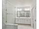 Bright bathroom with a large mirror, double vanity, and glass-enclosed shower at 3101 4Th N Ter, St Petersburg, FL 33713