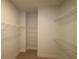Walk-in closet with carpeted flooring and metal shelving units on all sides at 3101 4Th N Ter, St Petersburg, FL 33713