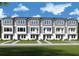 Beautiful townhome row with gray siding, white trim, and multiple windows at 3101 4Th N Ter, St Petersburg, FL 33713