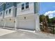 Townhome featuring neutral paint with a garage, a blue-green trim, and a wrought iron fence at 3101 4Th N Ter, St Petersburg, FL 33713