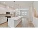 Clean, modern kitchen featuring an island with sink, stainless steel appliances, and white cabinets at 3101 4Th N Ter, St Petersburg, FL 33713