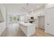 Modern kitchen with an island, pendant lights, and views of the open-concept living area at 3101 4Th N Ter, St Petersburg, FL 33713