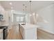 Bright kitchen island features a sink, white quartz countertop, pendant lights, and modern fixtures at 3101 4Th N Ter, St Petersburg, FL 33713