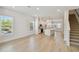 Open-concept living space with light wood floors, sleek kitchen, and modern staircase at 3101 4Th N Ter, St Petersburg, FL 33713