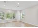 Bright and airy living room with large windows offering scenic views and light wood floors at 3101 4Th N Ter, St Petersburg, FL 33713