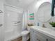 Clean bathroom featuring a shower/tub combo, toilet, and a sink with gray cabinet at 35149 Wagner Way, Zephyrhills, FL 33541